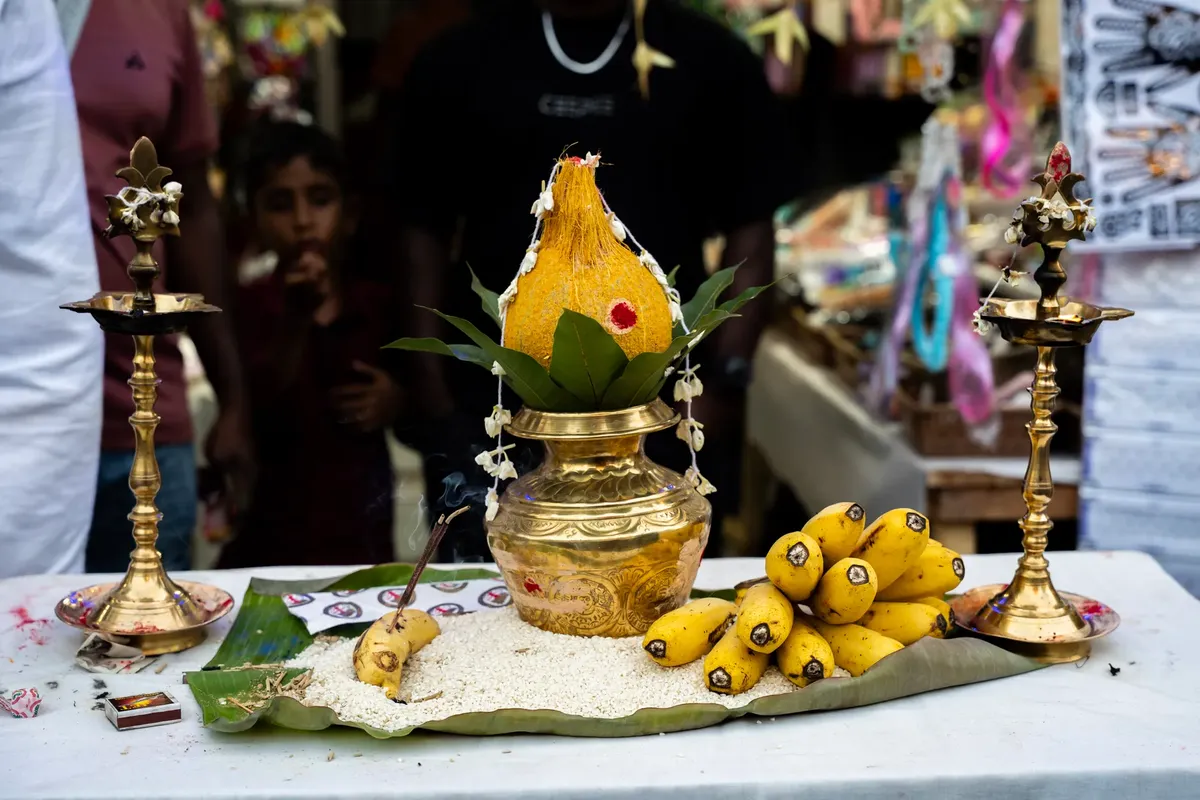 A vibrant setup for a Hindu ritual with traditional brass items, fruits, and decorative elements.