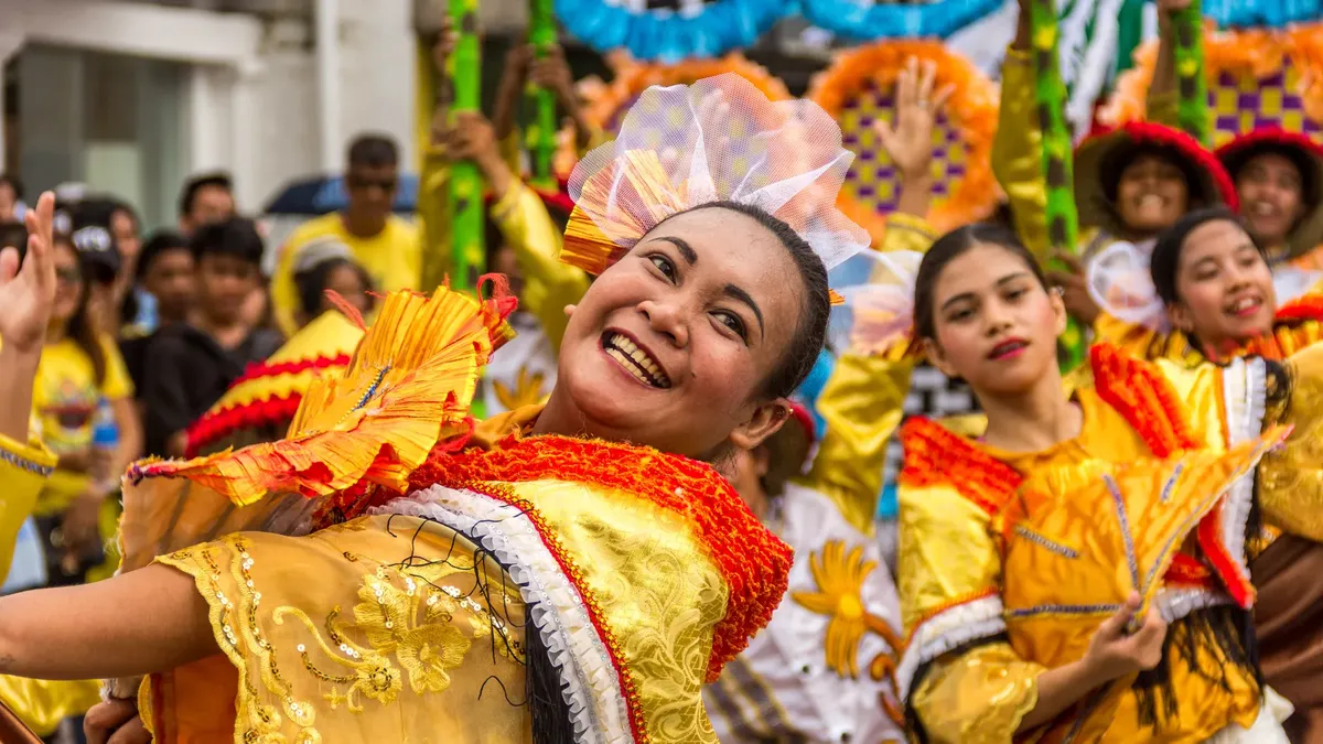 Colorful festival parade featuring joyful dancers in traditional costumes celebrating cultural heritage.
