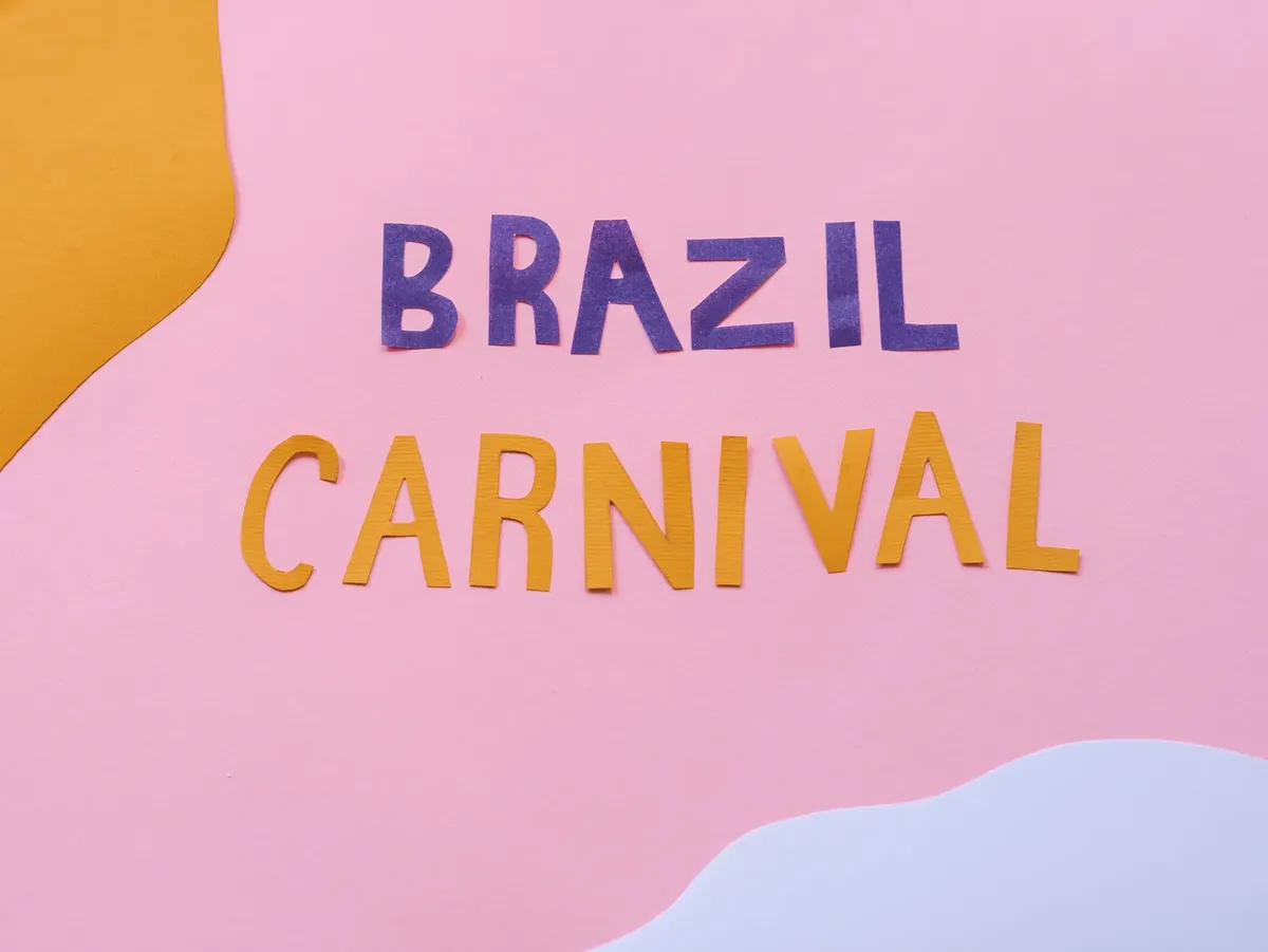 Vibrant paper cutout letters spelling Brazil Carnival on colorful background, perfect for festival promotions.