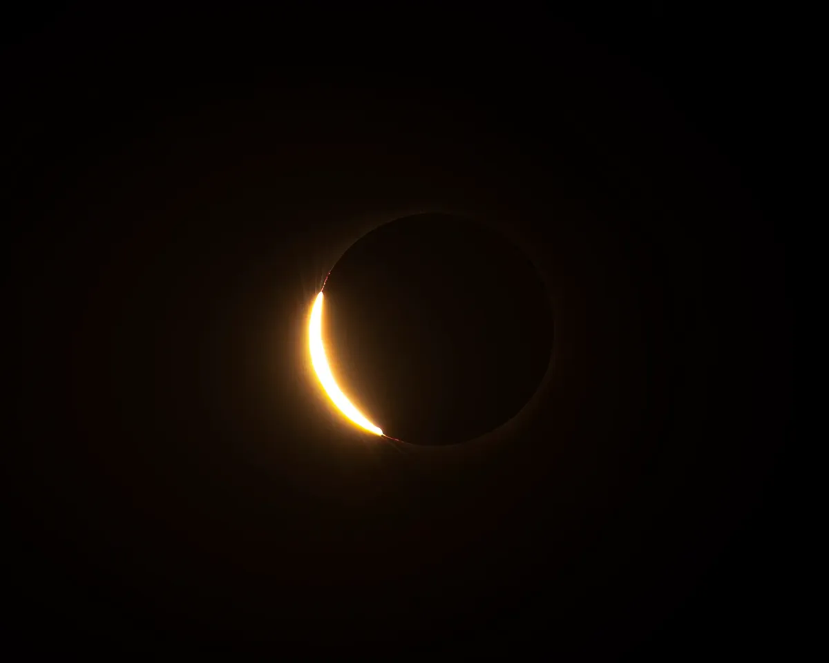 A breathtaking view of a solar eclipse with the sun's corona visible against a dark sky.