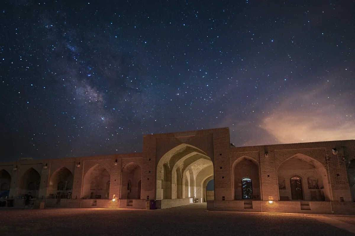 Telescope pointing at stars with ancient eyes gazing at planetary dance