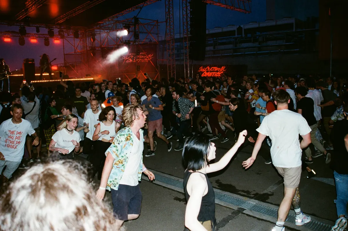 A lively concert crowd in a mosh pit during a music festival in Moscow, Russia.
